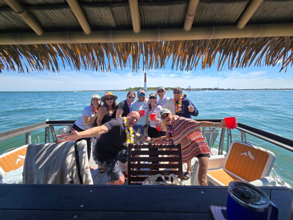 Guests cruising under the tiki roof on a Barnegat Light tiki boat tour