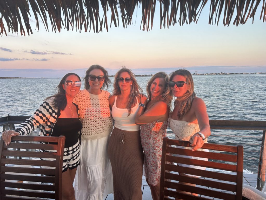 Group of friends posing at sunset on a Long Beach Island tiki boat cruise